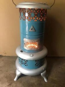 photo of a small, blue and white enamel coated, wood or coal burning heater made by the Royal Oak Company
