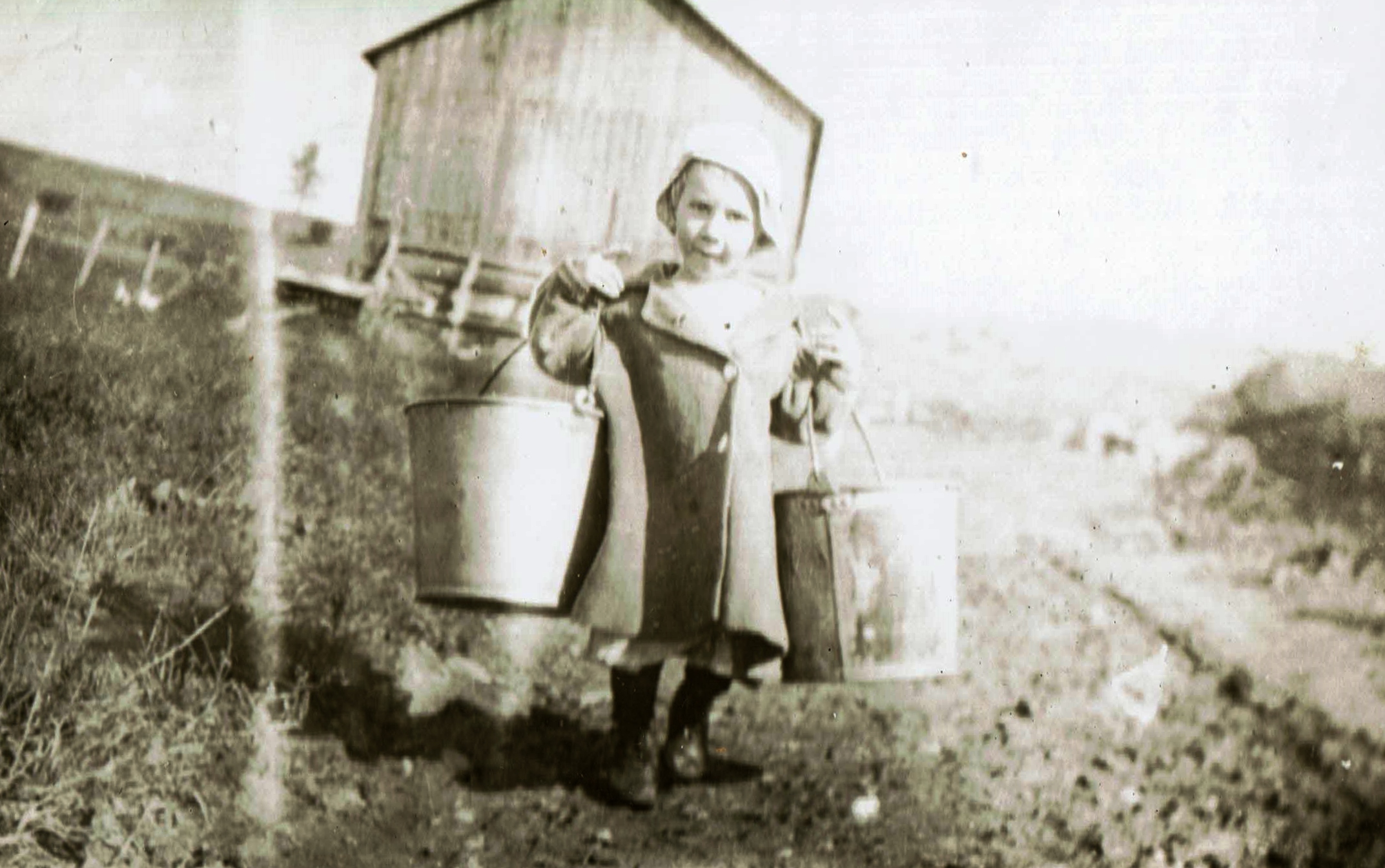Photo of Walter Thompson, Jr. carrying milk pails, ca 1920